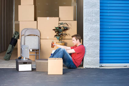 Man taking break in front of storage unit.